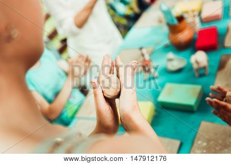 children's hands sculpts clay crafts pottery school