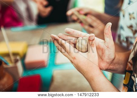 children's hands sculpts clay crafts pottery school