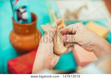 children's hands sculpts clay crafts pottery school