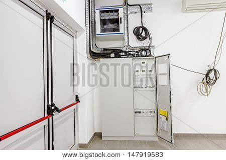 Smart home automation: display showing household consumptions related to temperature and heating. Automatic fuse electrical connector in power lines located inside of switch control panel board.
