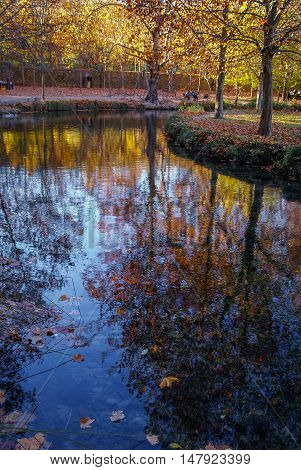 Autumn Landscape With Colorful Leaves, River And Reflections In Water