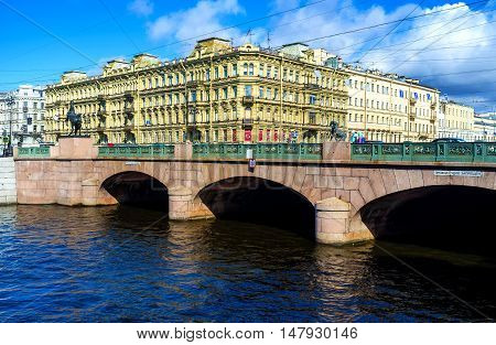 SAINT PETERSBURG RUSSIA - APRIL 25 2015: The best way to enjoy the Anichkov Bridge with the masterpiece statues of Horse Tamers by Pyotr Klodt is to overlook it from Fontanka River embankment on April 25 in Saint Petersburg.