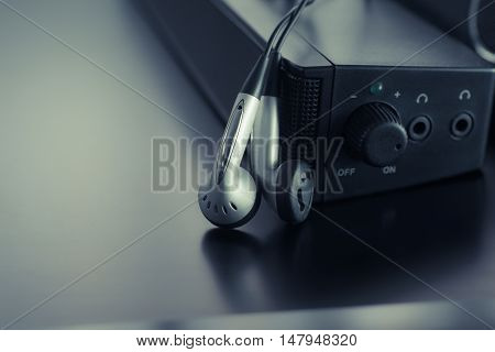 earpiece with speaker on modern dark background .