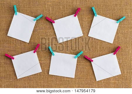 Six Misaligned Blank White Notepads On Hessian