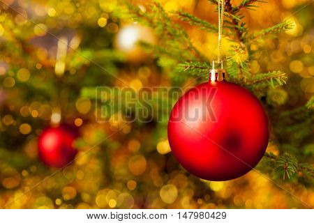 Christmas celebration holiday background - christmas-tree decoration bauble on decorated Christmas tree with defocused blurred lights bokeh and copyspalce
