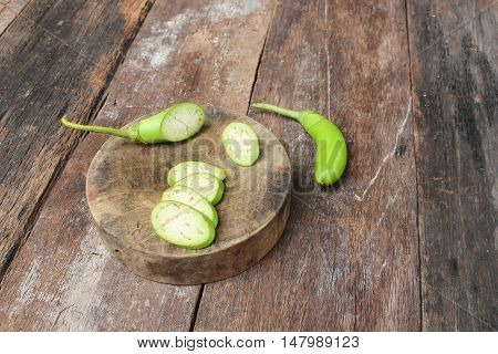 eggplants fresh cut in slices on a wooden background.  (Solanum melongena) and copy space.