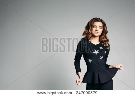 Sexy Sedactive Smiling Stylish Young Brunette With Long Hair And Make Up Posing And Holding Dress By