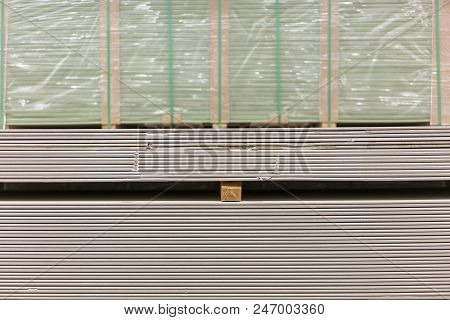 Pallet With Plasterboard In The Building Store. Warehouse With Plasterboard. Sheets Of Plasterboard 