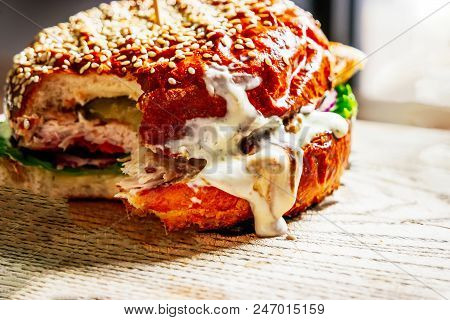 Burger With Cheese And Salad On A Wooden Board Bitten Off With Copyspace