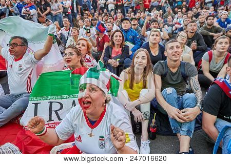 group of women watching football on big screen