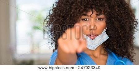 African american woman medical professional pointing with finger to the camera and to you, hand sign, positive and confident gesture from the front