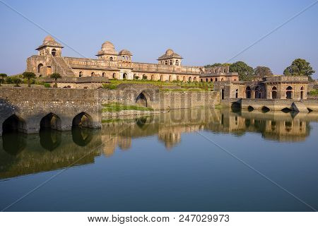 Jahaz Mahal , Ship Palace And Blue Water Lake In Sunrise. Mandu, Madhya Pradesh, India. Old Indian A