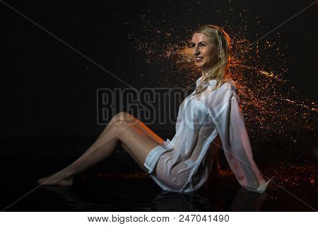 Nice Girl In The White Shirt And Water Drops Behind And Arround Her Illuminated By Light During A Ph