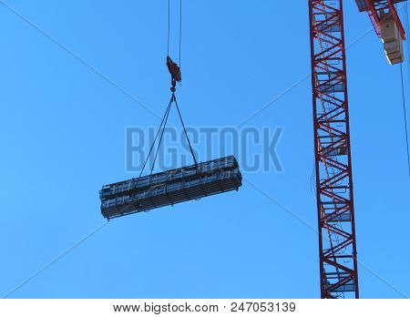 Hoist Of The Crane With A Heavy Load. Abstract Industrial Background With Construction Cranes Silhou