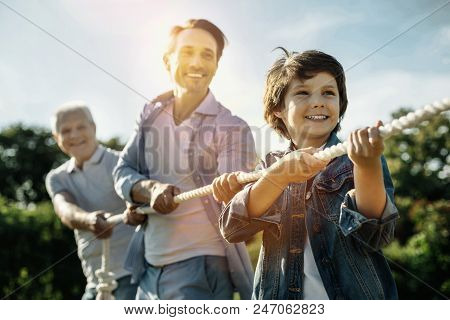 We Are Winners. Smiling Excited Determined Son Dad And Grandfather Standing One By One While Playing
