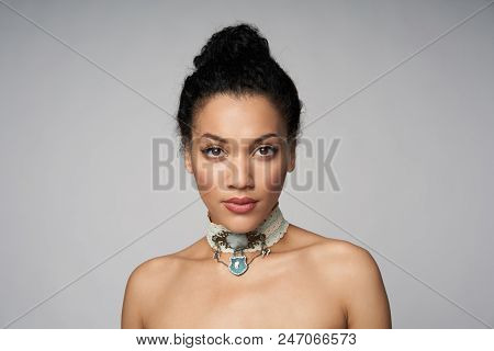 Beauty Closeup Portrait Of Beautiful Mixed Race Woman Wearing Chocker Posing, Isolated On Gray Backg