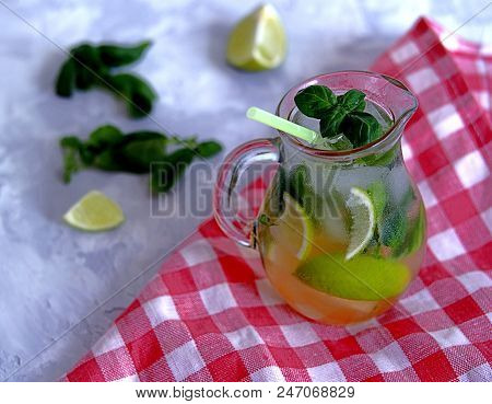 Cold Summer Drink, Lemonade With Lime And Basil On The Basis Of Sparkling Water And Sugar Syrup In A
