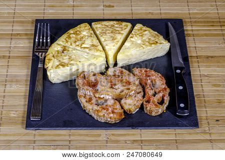 A Triangle Of Potato Spanish Omelette Prepared On Slate Plate And Covered With Bread With Tomato