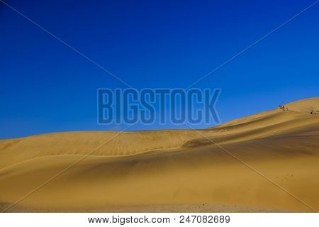 Swakopmund, Namibia - March 25 2018: Unidentified Tourists Give Sense Of Scale On Beautiful Expanse 