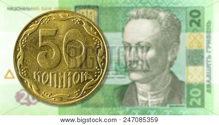 50 Kopiyka Coin Against 20 Ukrainian Hryvnia Bank Note Obverse