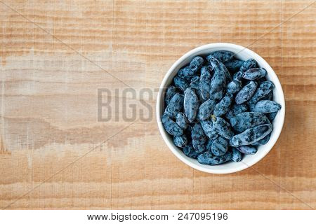 Honeysuckle, Woodbine Or Woodbind On White Plate On Wooden Table. Space For Text