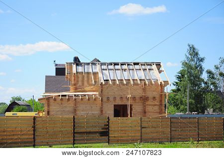 Roofing Construction. Roofer Contructor Installing Asphalt Shingles Roof On Waterproofing Membrane.