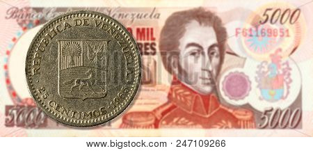 25 Centimos Coin Against 5000 Venezuelan Bolivar Bank Note (brown) Obverse