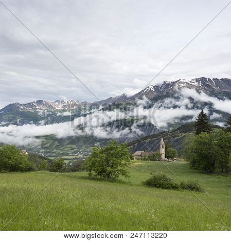 Mountains With Snow Of National Park Mercantour And Church Near Barcelonnette In Alpes De Provence.