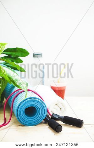 Set For Sports, A Yoga Mat, A Towel, Smoothies, Jumping Rope, A Bottle Of Water. The Concept Of A He