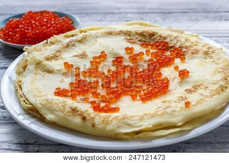 Pancakes With Red Caviar In A White Plate On A Wooden Background. Celebration Of Maslenitsa