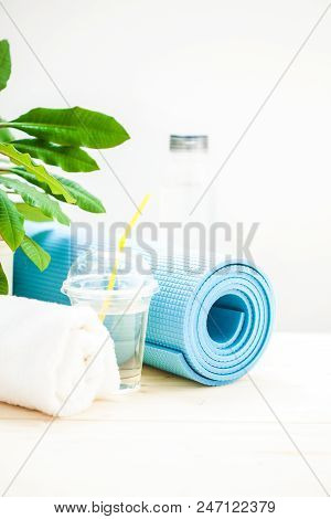 Set For Sports. Yoga Mat Towel And A Bottle Of Water On A Light Background The Concept Of A Healthy 