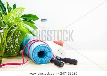 Set For Sports, A Yoga Mat, A Towel, Smoothies, Jumping Rope, A Bottle Of Water. The Concept Of A He