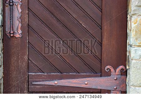 Wooden Doors With Iron Forging. Antique Wooden Antique Wooden Doors With A Forged Iron Elements.
