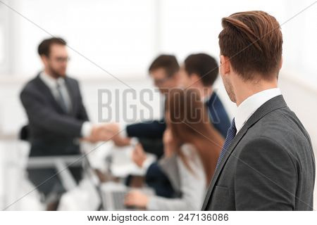 Business partners shaking hands over business objects on workpla