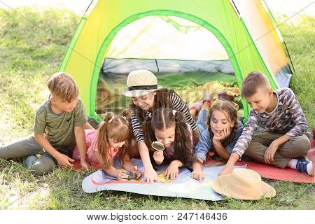 Little Children With Map Near Tent Outdoors. Summer Camp
