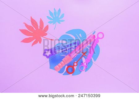 Bubble Wands On A Pastel Purple Background With Tropical Leaves And Copy Space. Summer Flat Lay Head