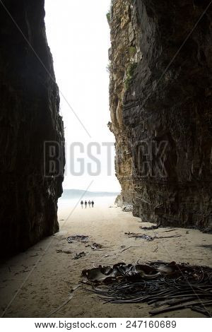 Group of people walking at Cathedrale Cove in Catlins in New Zealand southern island