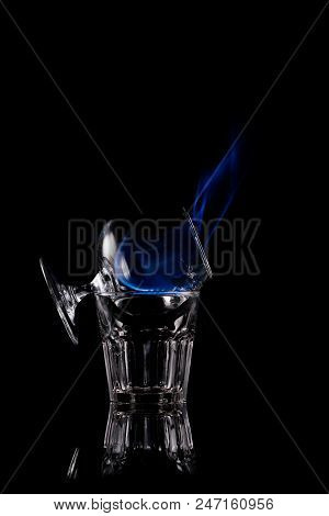 Close Up View Of Alcohol Sambuca Drink Burning In Glass On Black Background