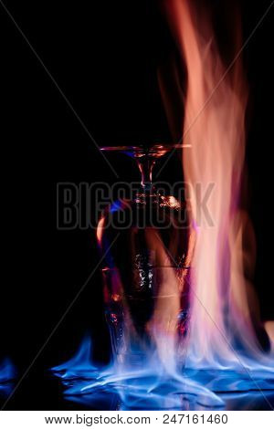Close Up View Of Alcohol Sambuca Drink In Glass And Flame On Black Background