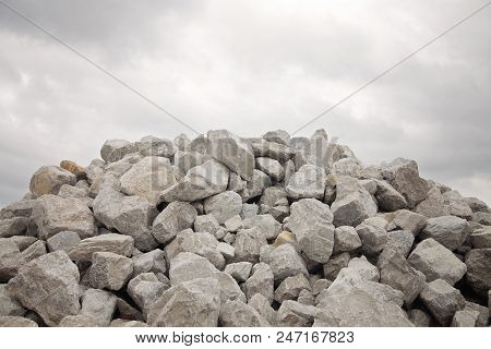 Large Pile Of Grey Bolder Rocks And The Sky
