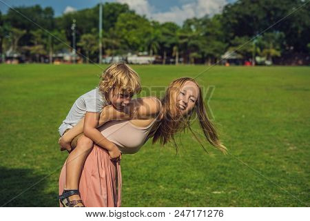 Mom And Son On Background Of Padang Kota Lama Or Simply Called The Padang, Is The Parade Ground And 