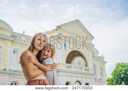 Mom And Son On Background Of Old Town Hall In George Town In Penang, Malaysia. The Foundation Stone 