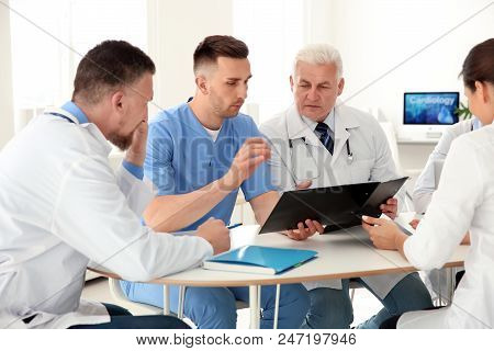 Group Of Doctors Attending Meeting In Clinic. Cardiology Conference