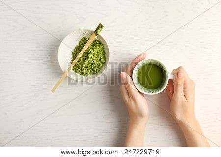 Woman With Cup Of Matcha Tea At Table, Top View