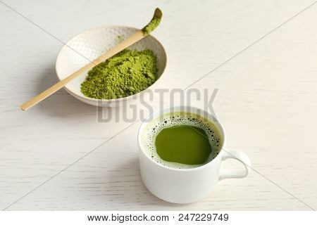 Cup Of Fresh Beverage And Chawan With Powdered Matcha Tea On Table