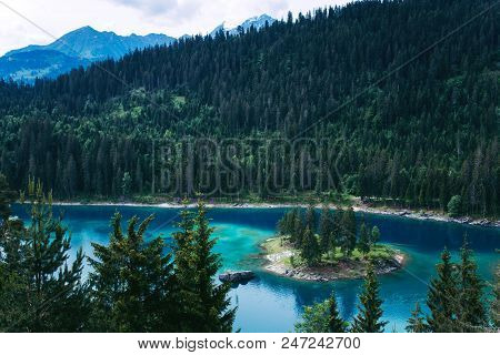 Caumasee Lake With A Small Island Located In The Middle Of The Crystal Clean Lake, Near Flims, Switz
