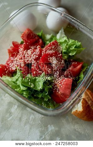 Delicious, Simple And Nutritious Meal. Fresh Tomato Salad, Baguette And Boiled Eggs. On A Gray Backg