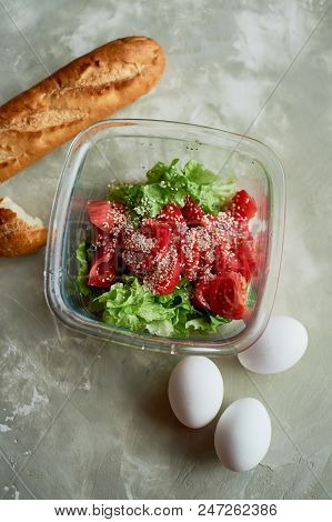 Delicious, Simple And Nutritious Meal. Fresh Tomato Salad, Baguette And Boiled Eggs. On A Gray Backg