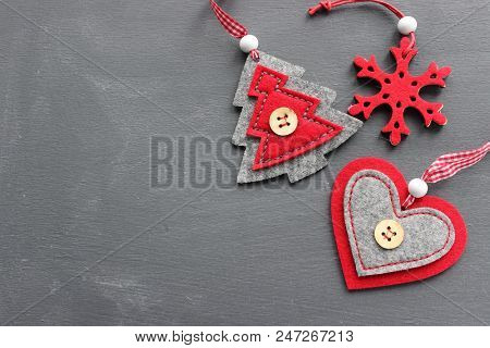 Christmas Textured Gray Background With Red Felt Toys. Free Space For Writing Texts