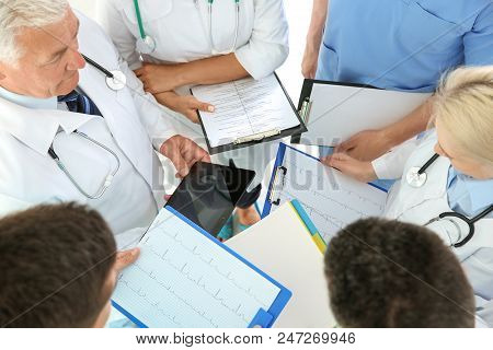 Group Of Doctors Attending Meeting In Clinic. Cardiology Conference